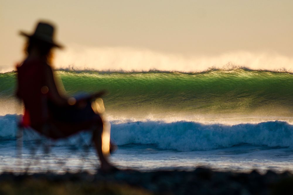 Anne Gilbert Chase relaxing reading on the beach at the Wall in Baja Mexico.