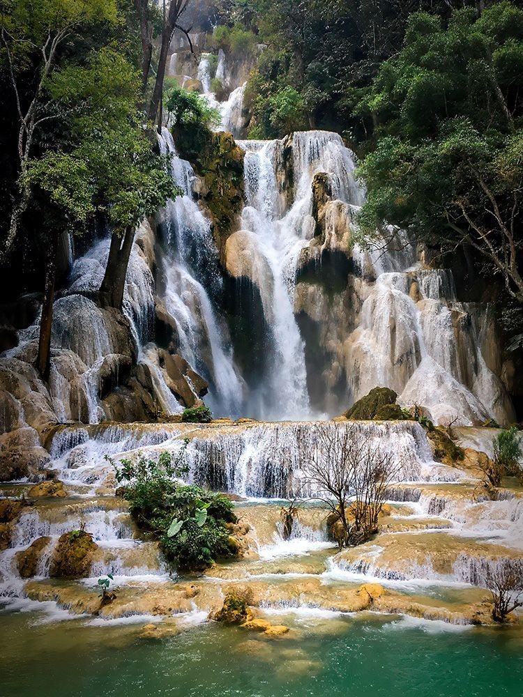 Turquoise cascades and forest pools at Kuang Si Falls near Luang Prabang, Laos