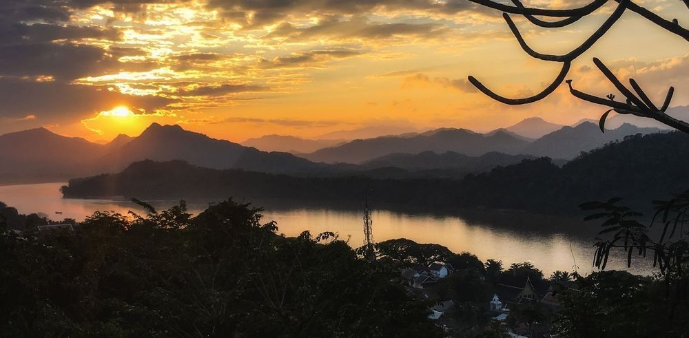 Sunset over Luang Prabang, Laos, viewed from Mount Phou Si with the Mekong River and mountains in the distance