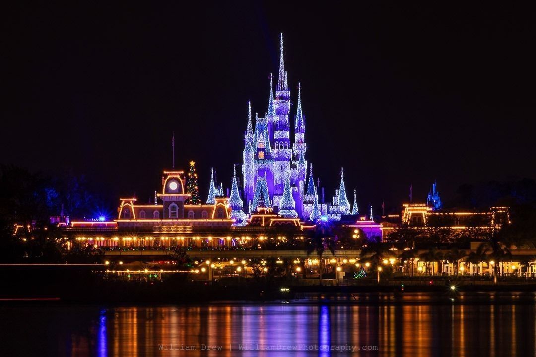 Magic Kingdom Christmas - A Look across Seven Seas Lagoon at the Magic Kingdom with Christmas decorations and Cinderella Castle lit up with Christmas Dreamlights