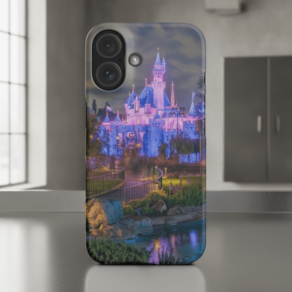 Sleeping Beauty Castle at night with glowing fountain iPhone case
