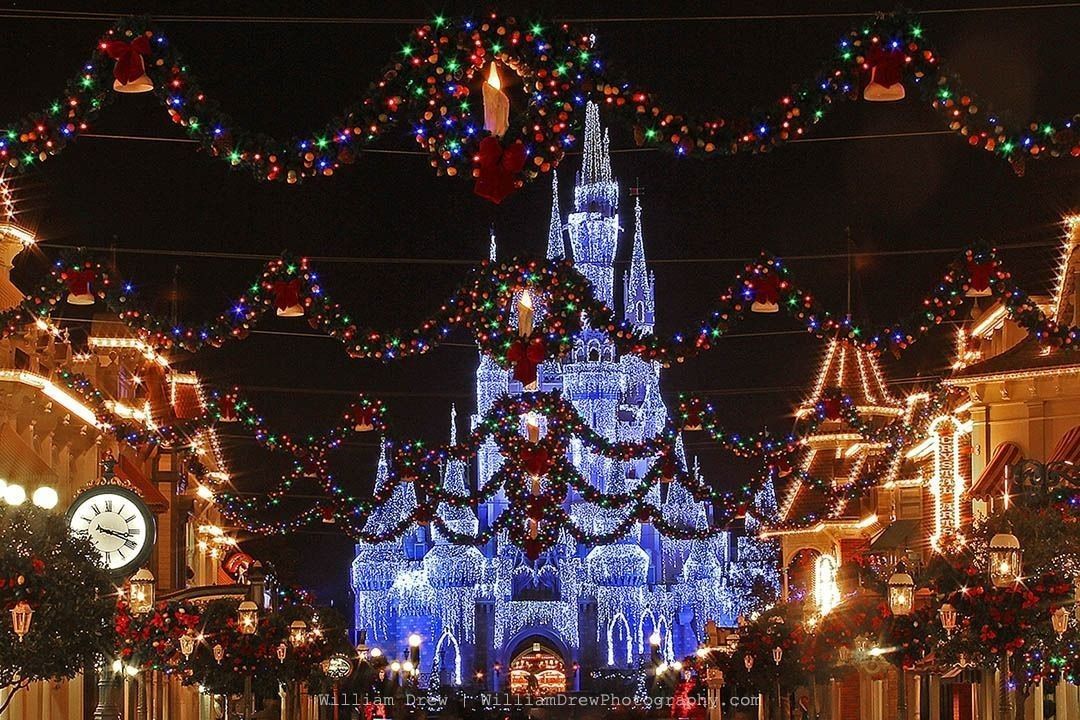 Magic Kingdom at Christmas - A View looking down Main Street USA decorated for Christmas with Cinderella Castle in the background