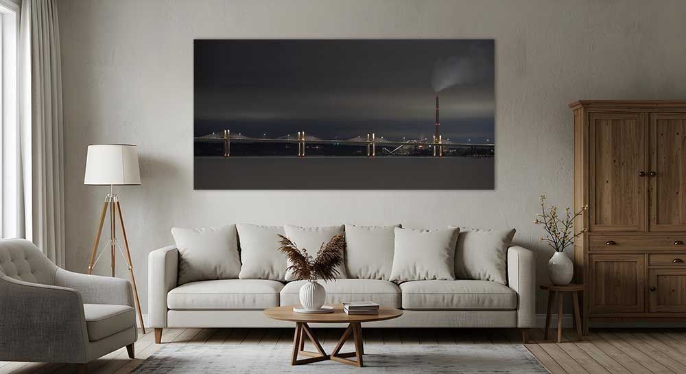 Fracture in Time metal print displayed above a light gray sofa in a living room, St. Croix Crossing bridge night photography