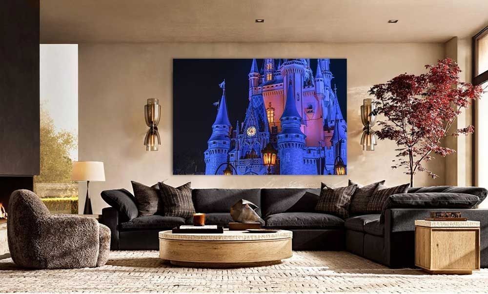 A nighttime Cinderella Castle print on a living room wall