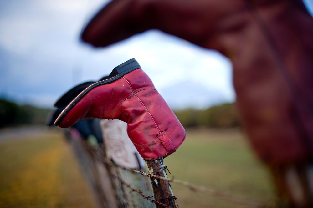 Public Art setting of used boots on a ranch west of Keerville, Texas