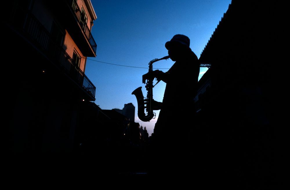 French Quarter street musician plays his sax for spare change in New Orleans, Louisiana.