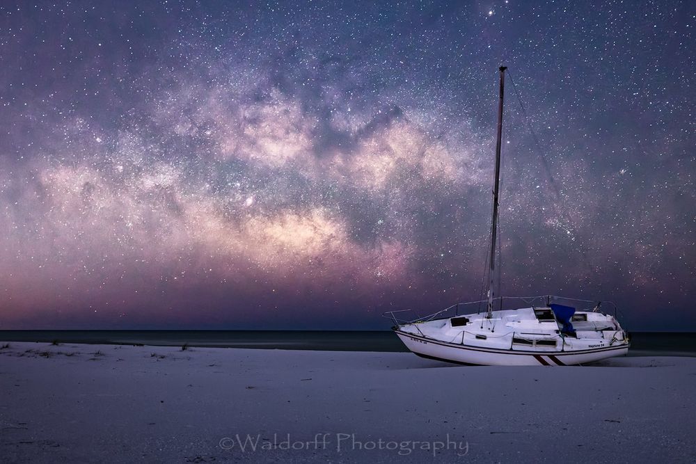The Milky Way rising over a sailboat on Gulf Islands National Seashore | Waldorff Photography | Fine Art Prints on Canvas, Paper, Metal, and Acrylic