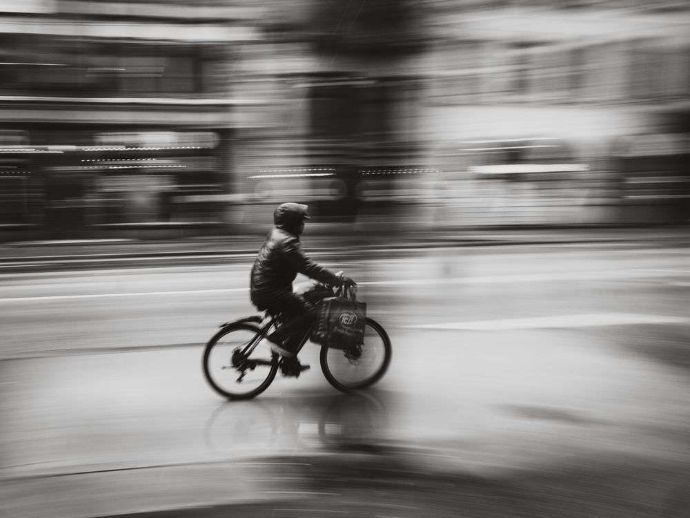 Velocity in the Rain – Panning Cyclist Street Photography by Luis R.R. Siqueira