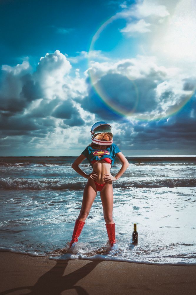 Woman in a space helmet at the beach