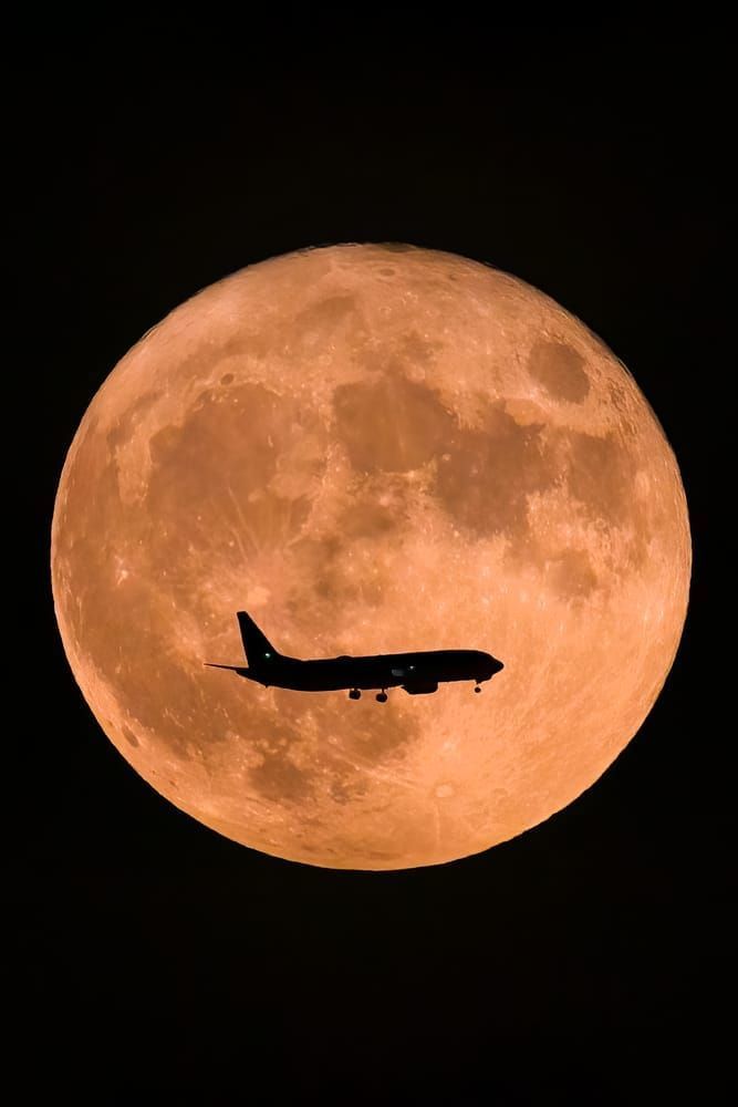 Moon Landing - Airplane Silhouette Against Full Moon