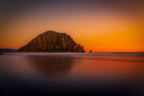 Morro Rock At Twilight — A Quiet Sentinel In Warm, Reflective Light Photography Art | Harry Beugelink Photography