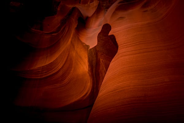 Thumbs Up. A thumb shape carved by erosion in the smooth curved Red Navajo Sandstone walls of Owl Canyon, one of the famous Slot Canyons in the Navajo lands near Page Arizona, United States. It was interesting that we stood right in front to the fea