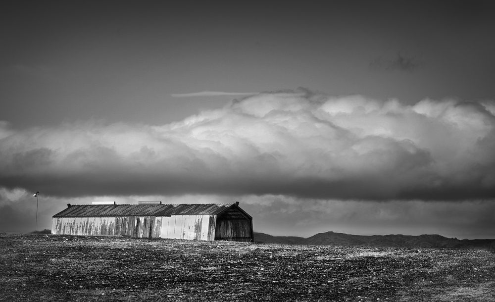 Snow-bearing clouds lower themselves over Yolo County farmland between winter storms.
