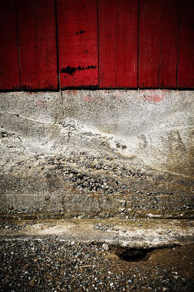 Vividly painted wood and roughly finished concrete together form a barn wall at Yolo Land and Cattle Company.