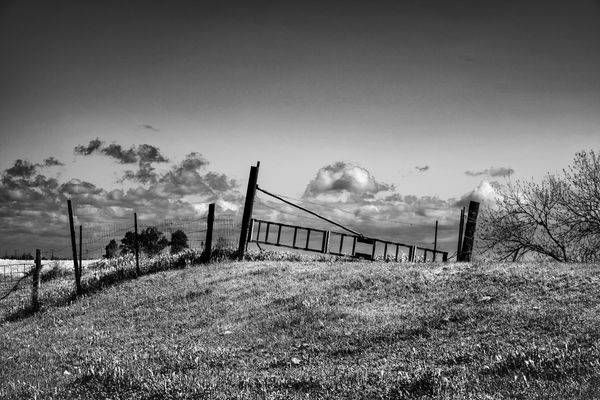 A gate atop a levee helps separate farm land from a deep-sea channel that runs through Clarksburg, California.