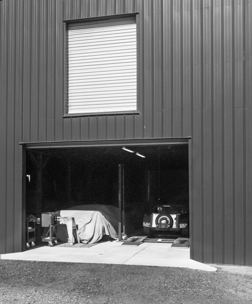 Performance cars await service in a barn workshop at Clos Cavanis Farm, Yolo County.