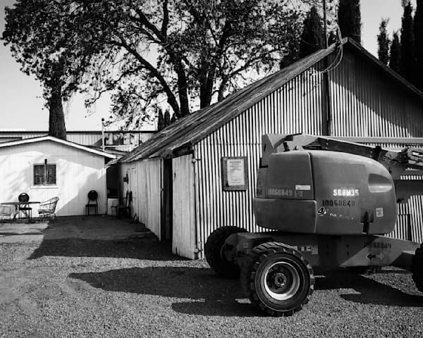 An excavator stands ready near sheds at Capay Canyon Ranch, Yolo County, California.