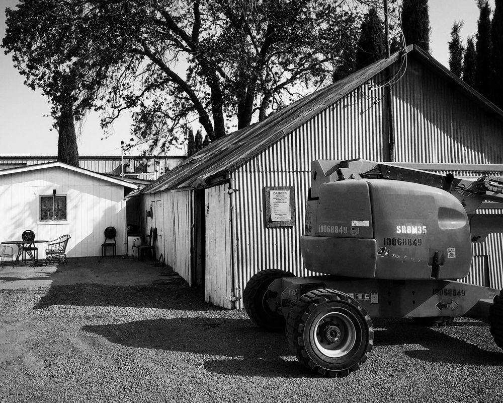 An excavator stands ready near sheds at Capay Canyon Ranch, Yolo County, California.