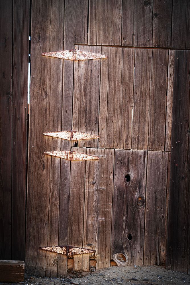 Rusting hinges still hold together a weather-beaten door to a barn on the Rodegerdt family ranch.