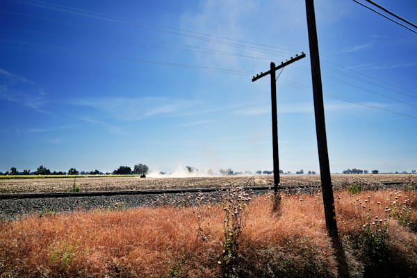 Dust blooms from the tilling of a family farm field in Yolo County, California.