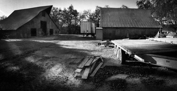 Morning light throws shadows across the farmyard in a panorama from Rominger Brothers Farm in Yolo County, California.