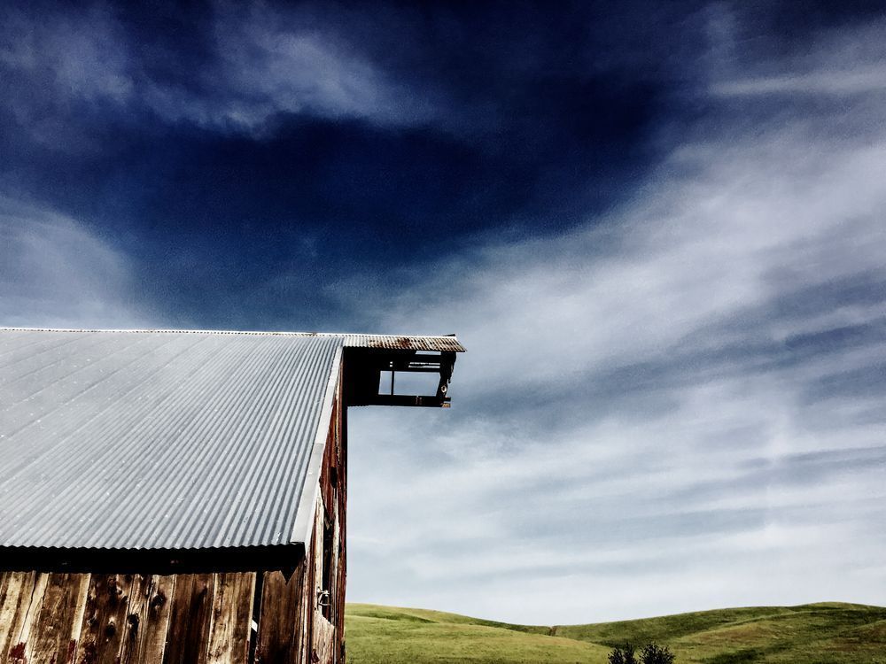 A weathered barn stands against the intense California sky in Yolo County.