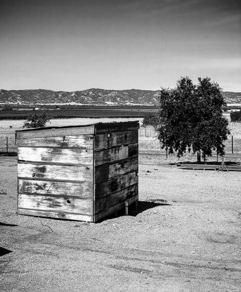 A weathered shed protects an irrigation pump from the elements at Pheasant Trek Ranch, Yolo County, California.