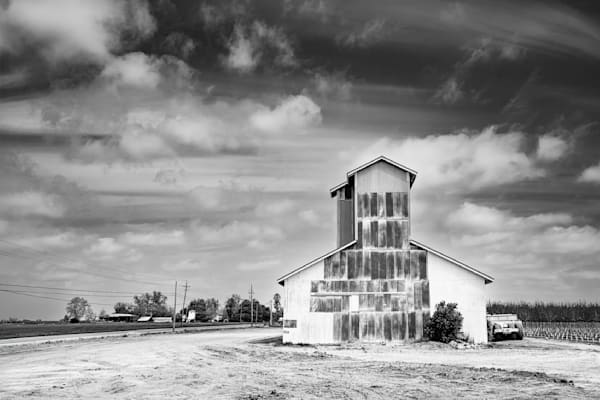A partially restored building undergoes restoration in the farmland of Northern California.