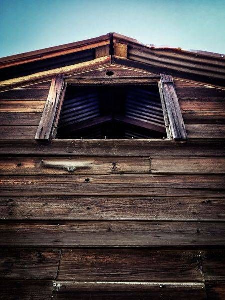 Light enters the peak of a weathered barn at Rominger Brothers Farm in Yolo County, California.
