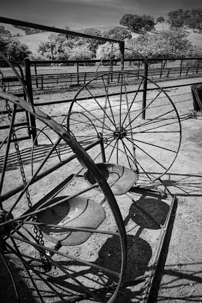 Rusting seats and frame are all that is left of antique farm equipment at Yolo Land and Cattle Company.
