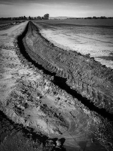 A tractor has plowed a graceful arc through a farm field in Yolo County, California.
