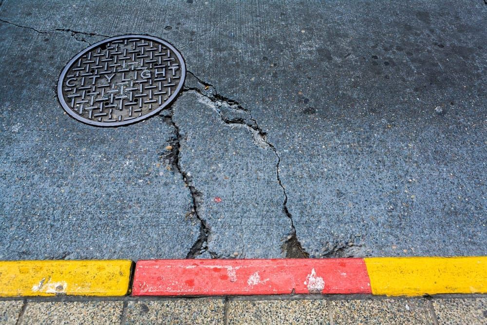 Bus, curb, cracks, manhole, concrete