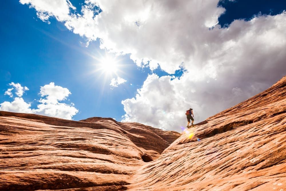 A woman out on a day hike in Canyonlands National Park, Utah, USA. Squaw Canyon in The Needles District.