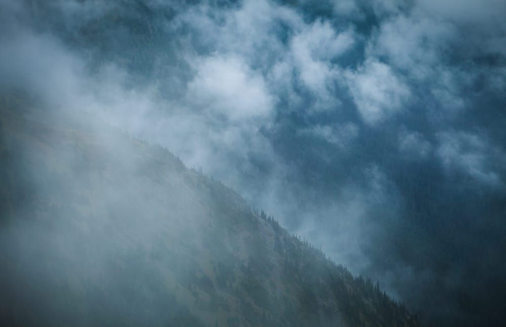 View of a mountain ridge from above looking through clouds.  North Cascades near Harts Pass, Washington, USA.