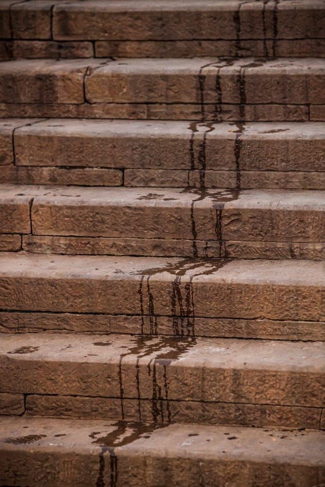 Water drips down the steps to the Ganges river in Varanasi India after a bather ascended the steps.