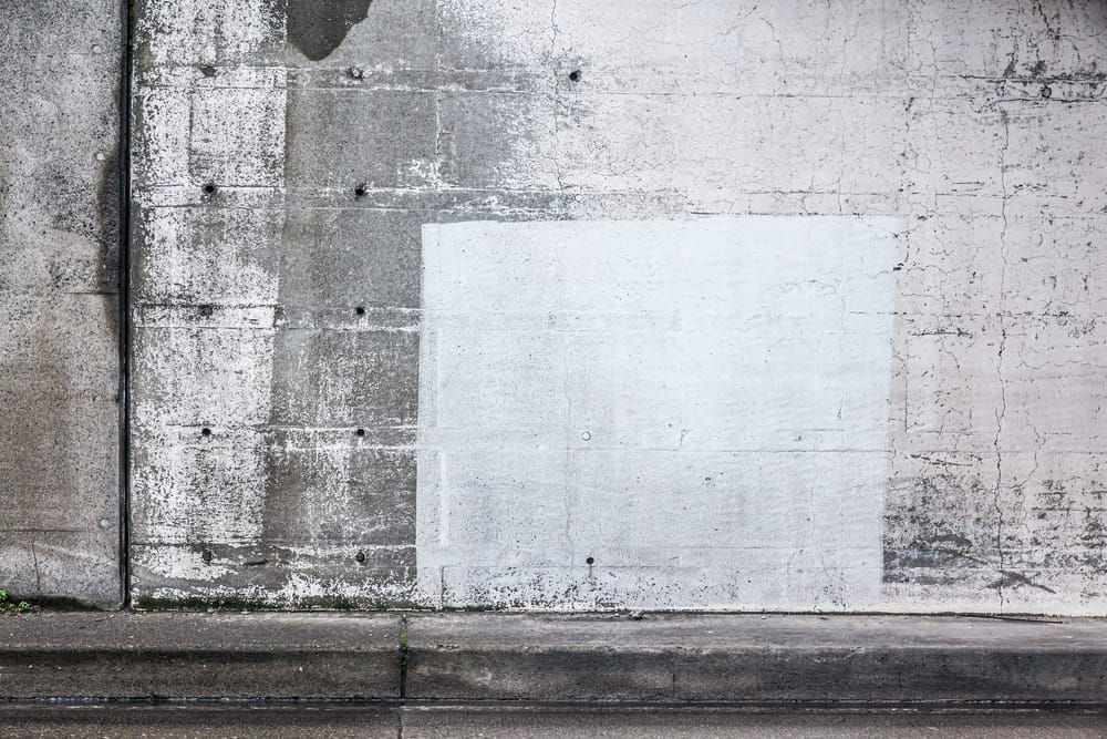 A section of a concrete wall inside an underground roadway tunnle.