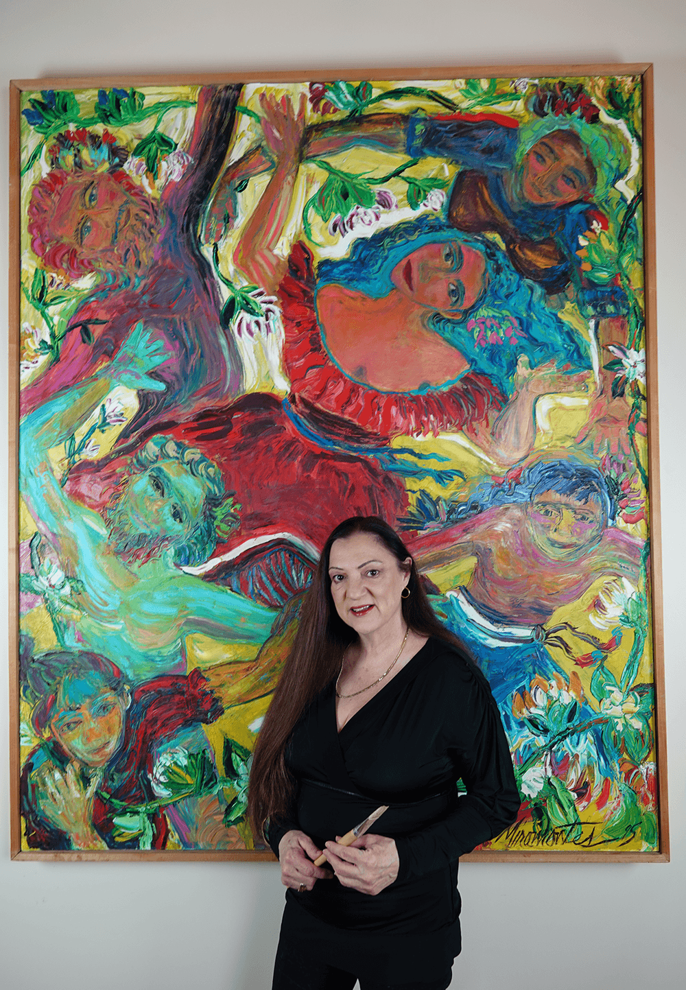 Artist Rita Miramontes standing in front of her large original oil painting The Bride, showing its life size scale