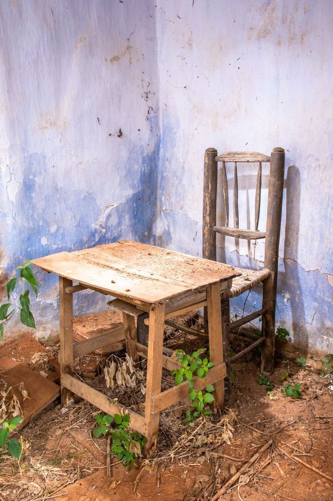 Childhood Remains - Abandoned children’s study table inside a ruined space