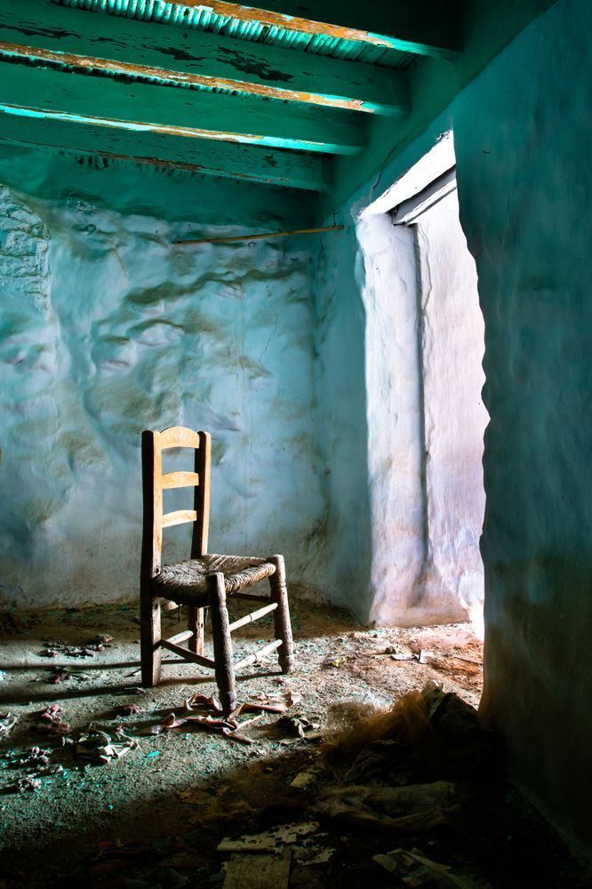 Another life - Fine art photograph of a chair facing light in an abandoned space