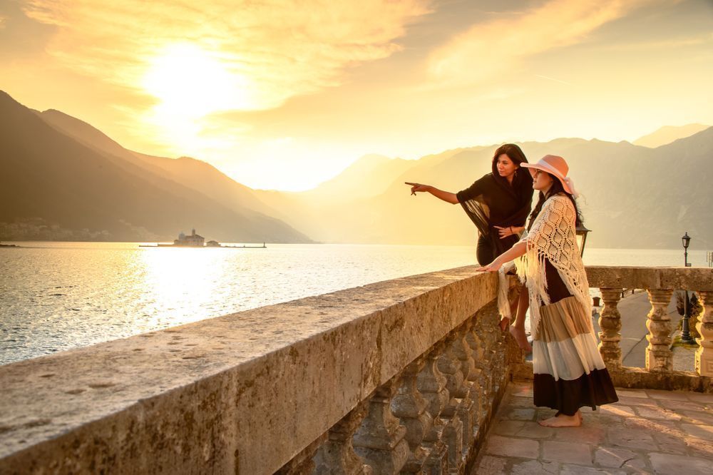 Looking Beyond - Two women overlooking Kotor Bay at sunset in Montenegro
