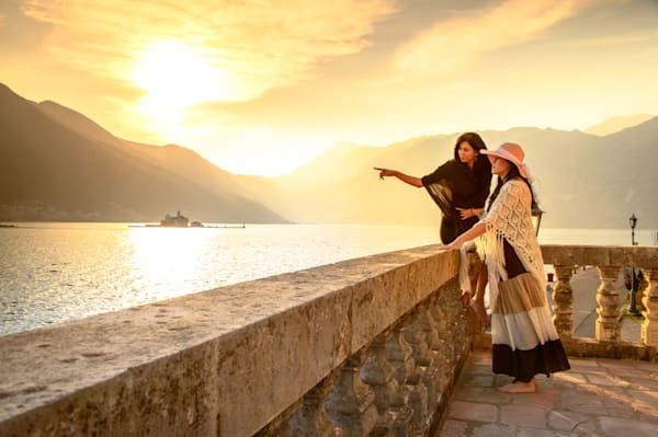 Looking Beyond - Two women overlooking Kotor Bay at sunset in Montenegro