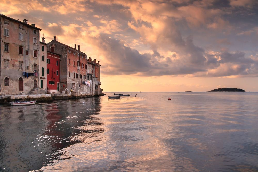 Where the Sea Meets the Town - Mediterranean townscape with colorful buildings reflected in calm sea - Rovinij, Croatia