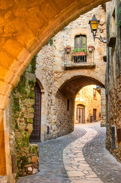 Through the Arch - Mediterranean street with depth, detail, and soft golden tones