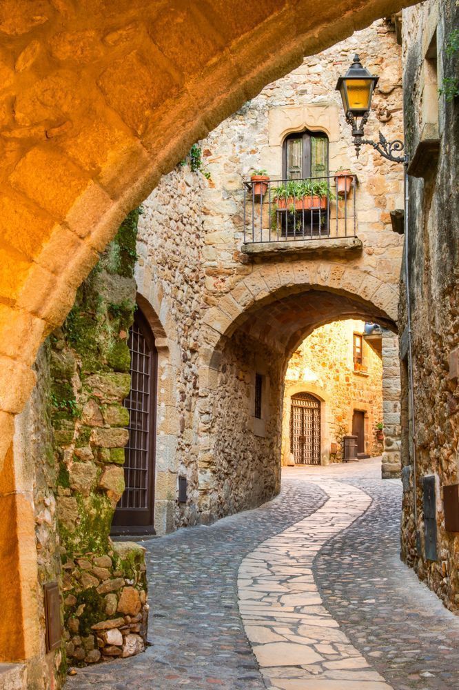 Through the Arch - Mediterranean street with depth, detail, and soft golden tones