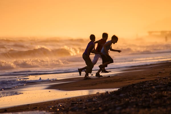 The Joy of the Sea - Children running on a Mediterranean beach in warm natural light