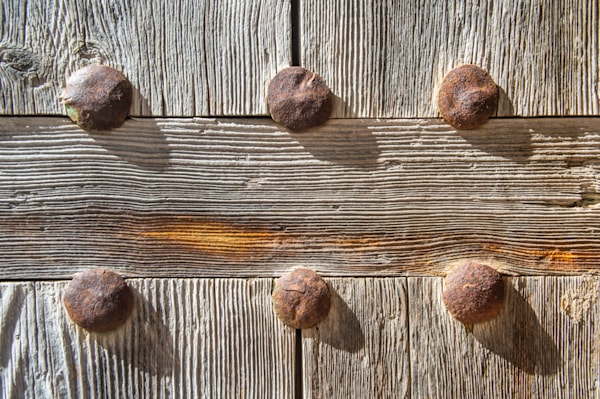 The Armored Door - Rustic Mediterranean door with iron details and aged wood