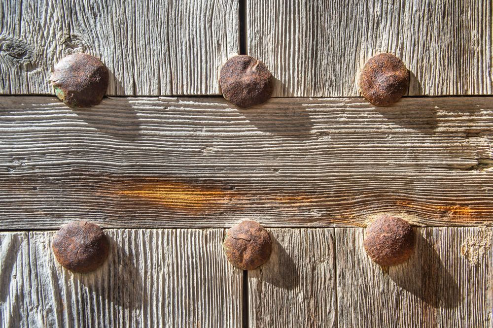 The Armored Door - Rustic Mediterranean door with iron details and aged wood