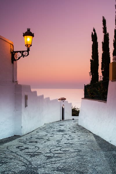 The Quiet Street - Empty white street in Nerja during soft sunrise light