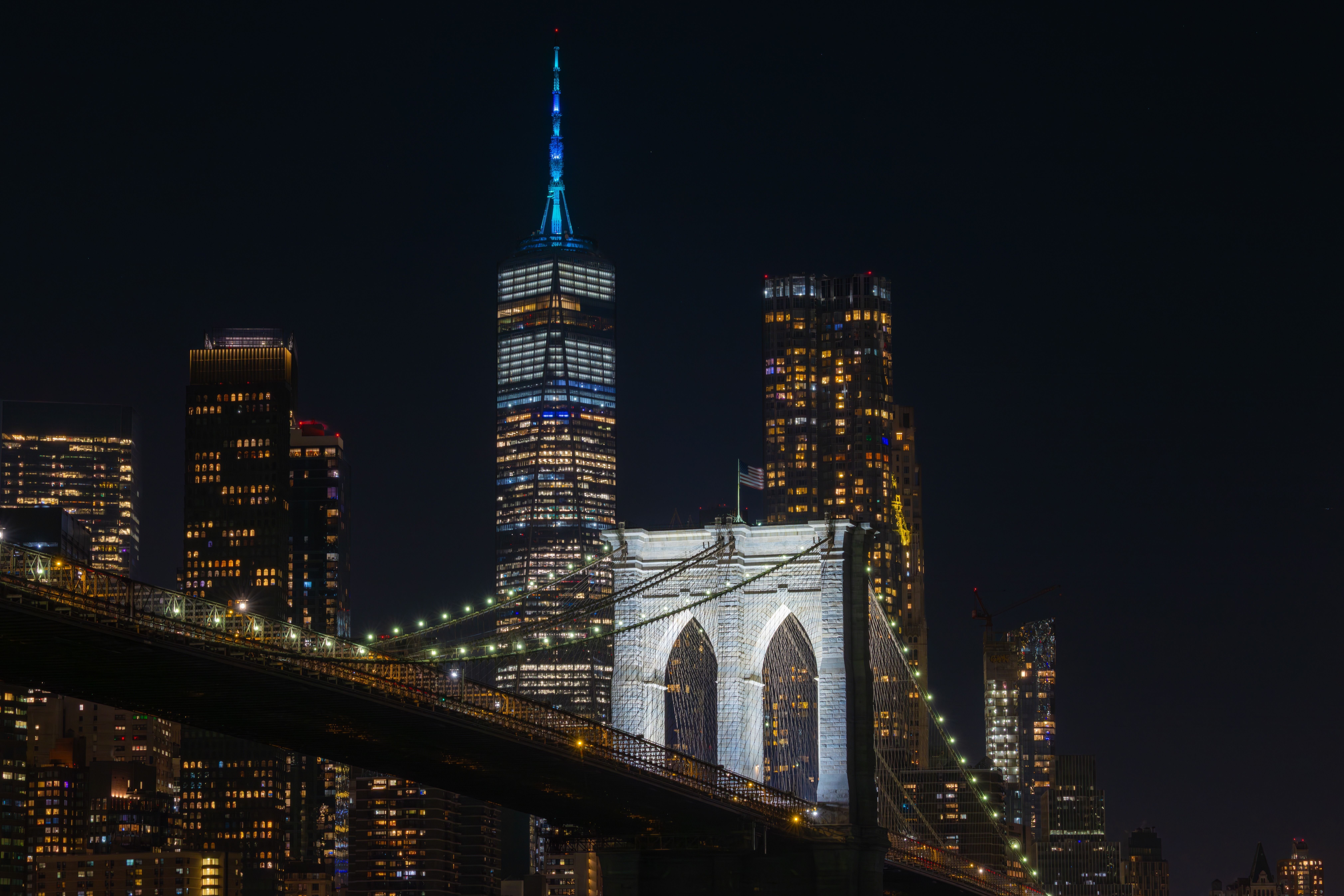 
        <div class='title'>
          The New, Anchored by the Old, Brooklyn Bridge
        </div>
       