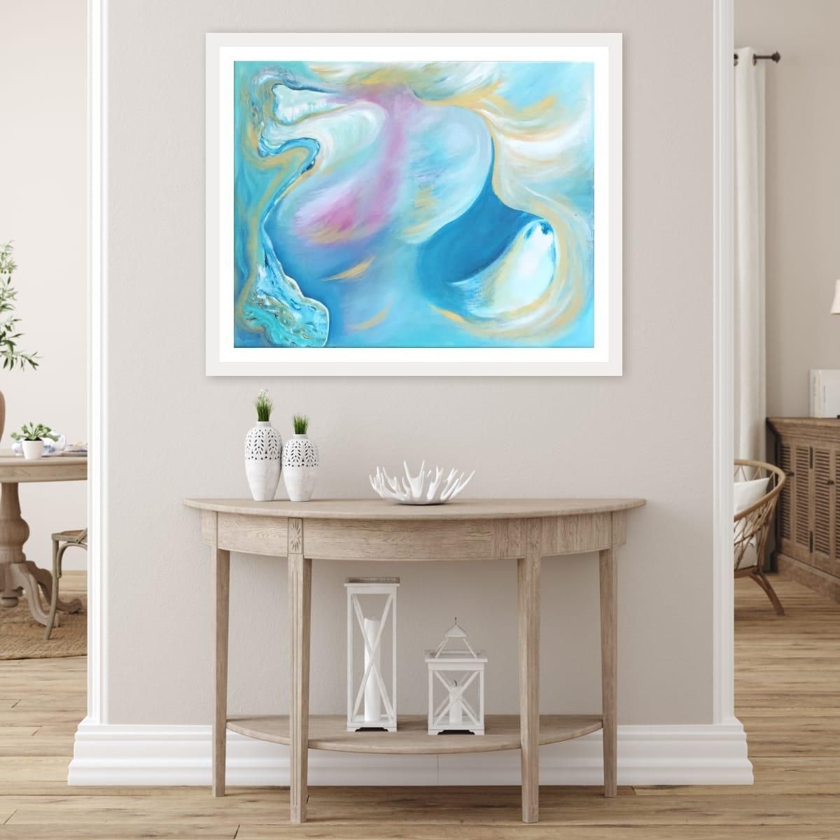 Intercessor open-edition fine art print in white frame above a console table in a warm neutral entryway